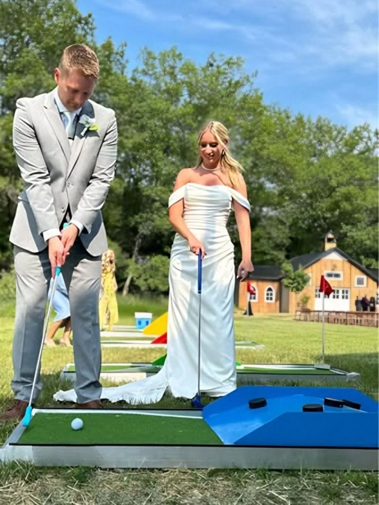 Bride and groom playing mini golf at their wedding