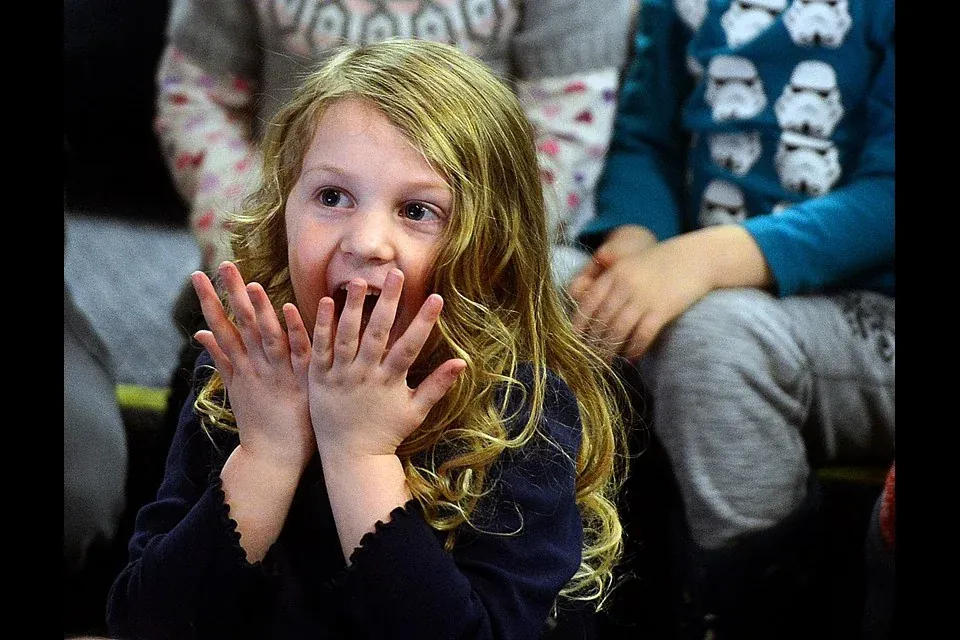 A delighted audience member reacts during a live magic show